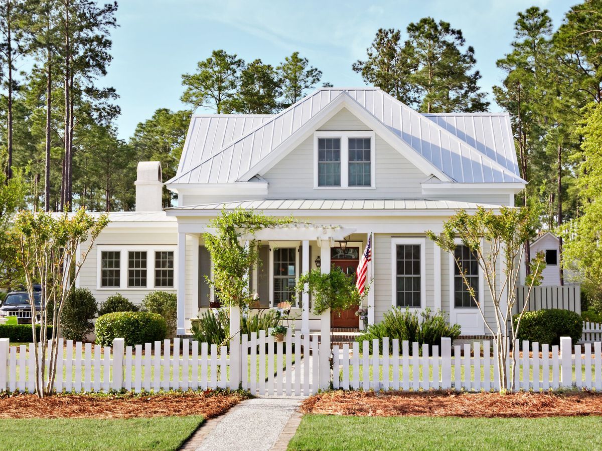 White house with a light gray metal roof. 0720_AA_Metal_Roofs_18_HL_CottageE_crop