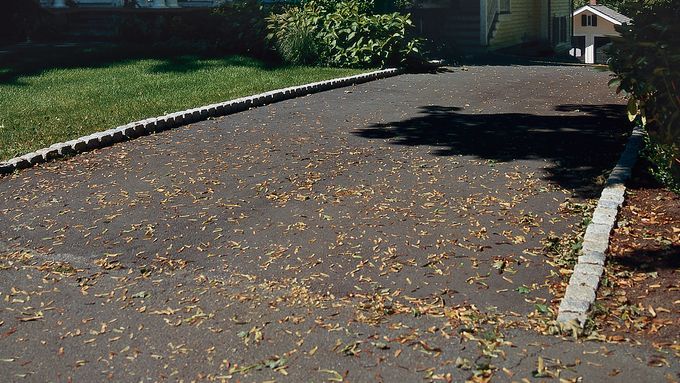 A belgian brick driveway leading up to a house