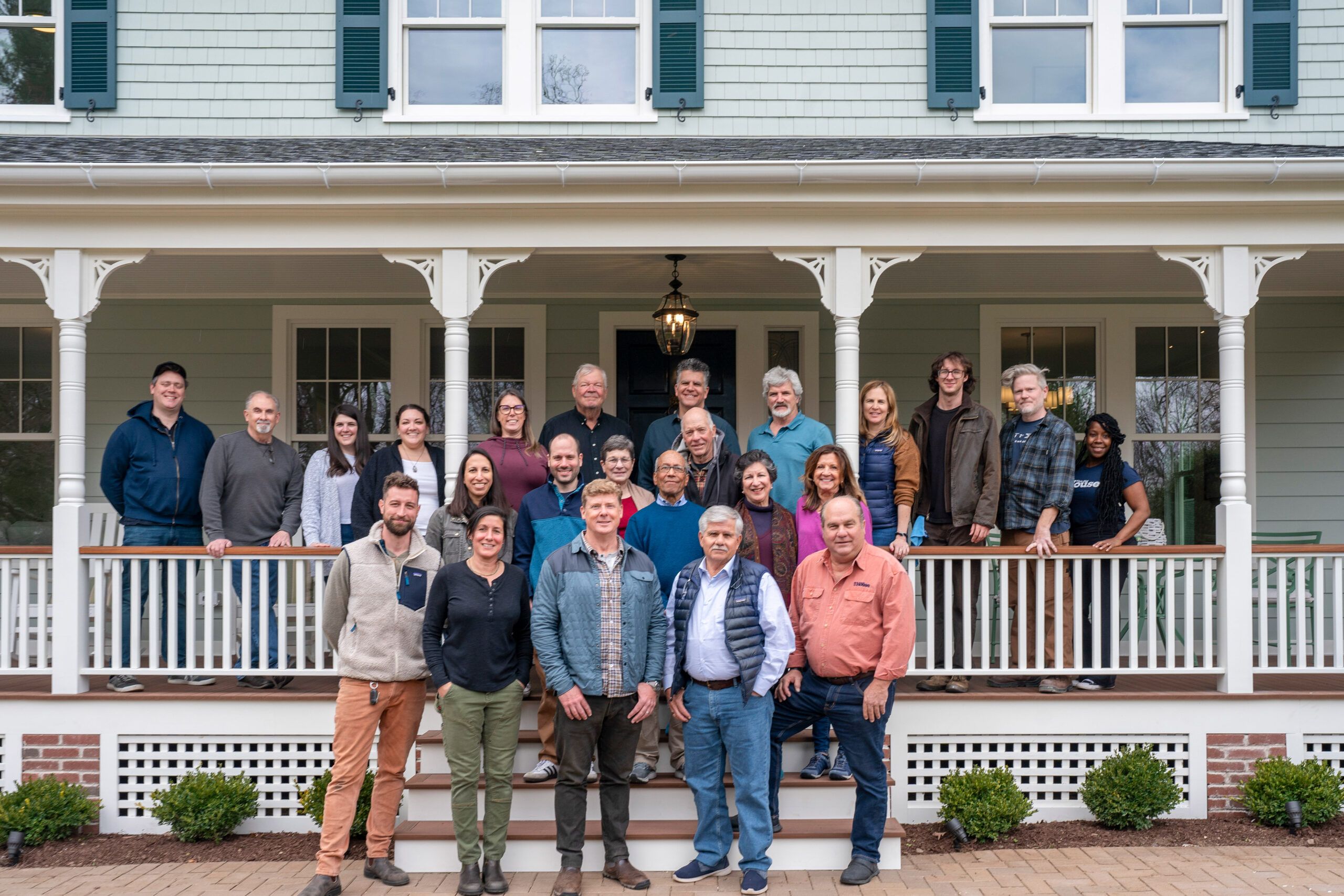 Cast and crew of TOH standing on the porch of the Glen Ridge House