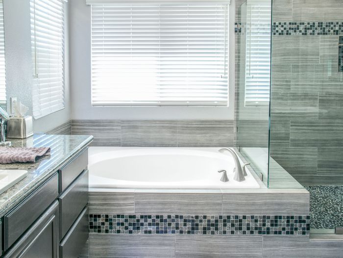 A bathtub that has been deep cleaned, it is white and spotless.