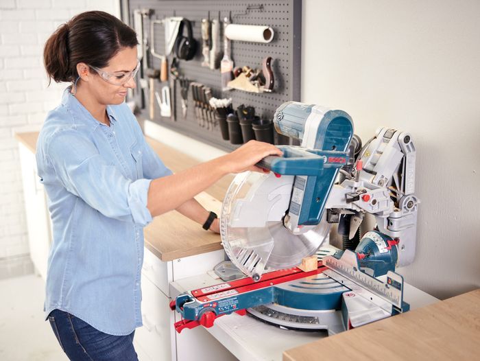 Jenn Largesse in her workshop using a Bosch miter saw