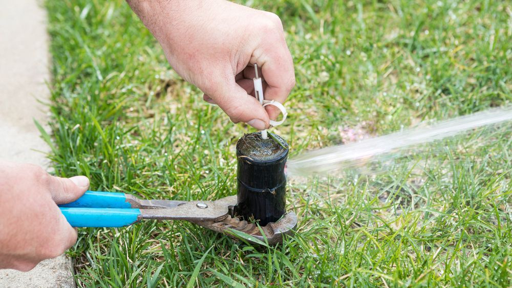 Turning on a sprinkler system with a key and pliers