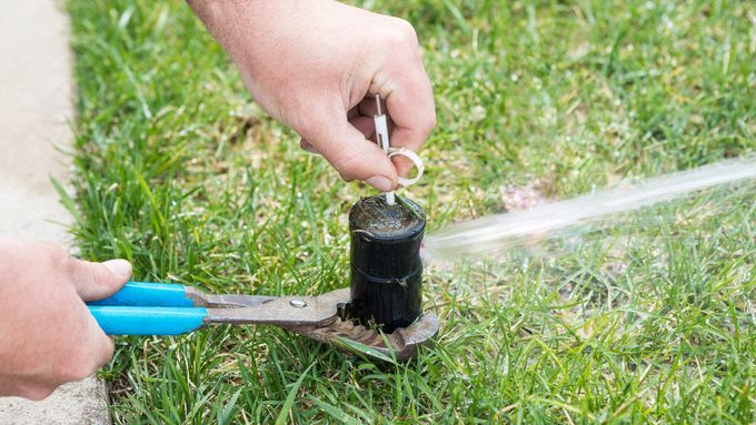 Turning on a sprinkler system with a key and pliers